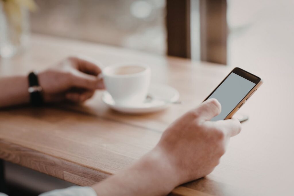 Person using phone at a table