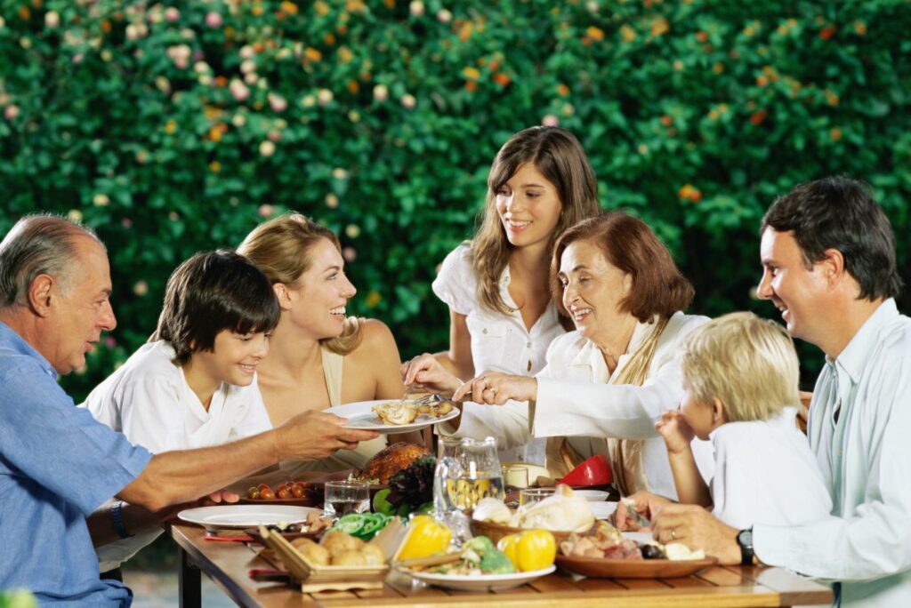 Family sharing a meal outdoors